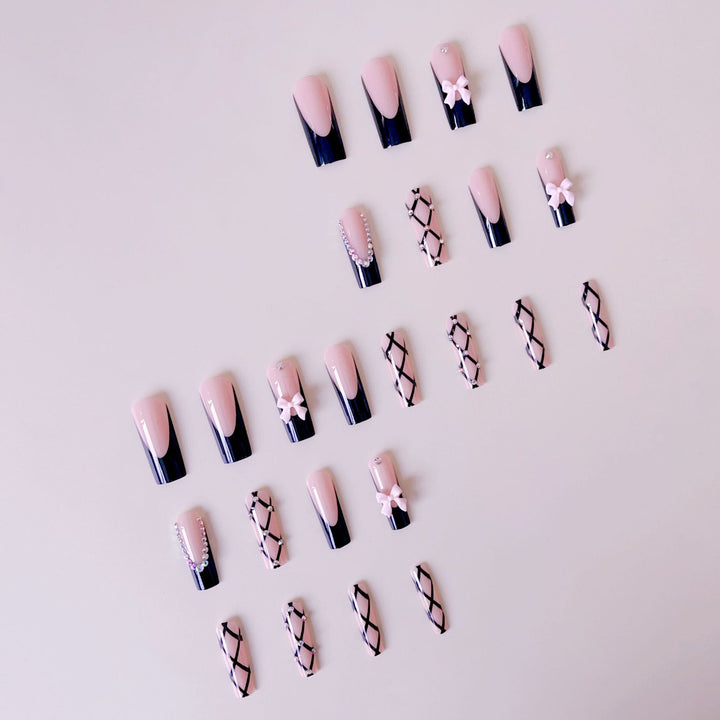 Artificial nail set with glamorous rhinestone and bow accents Stornfield