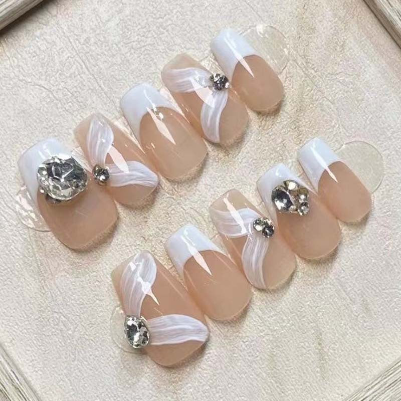 Elegant artificial nail set with delicate decorations and glitter elements Stornfield