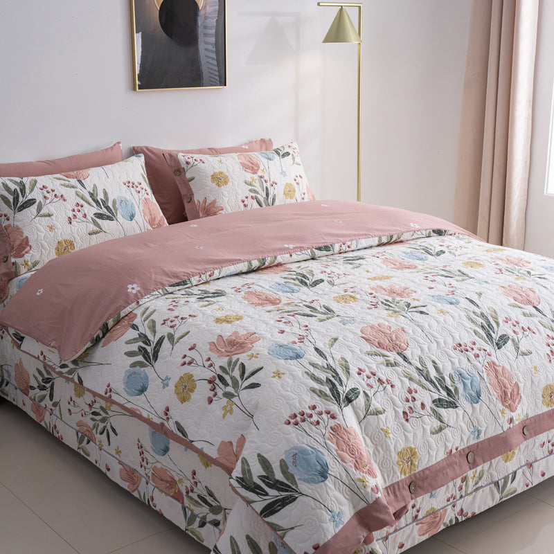 Quilted bedspread and bedding set with floral print, reversible function and decorative button placket