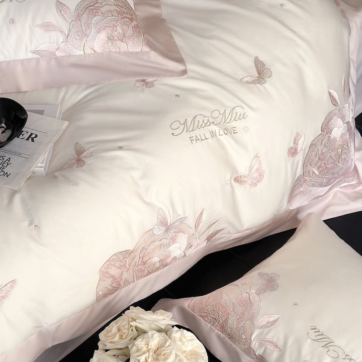 Luxurious satin bedding set with delicate rose and butterfly embroideries