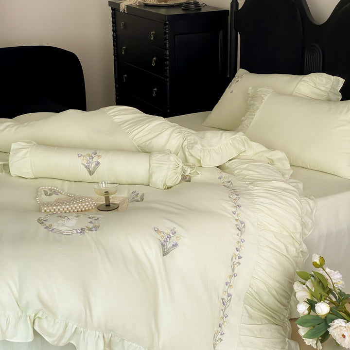 Premium bed linen set made of cotton percale with fine ruffle trim and embroidered calla motifs