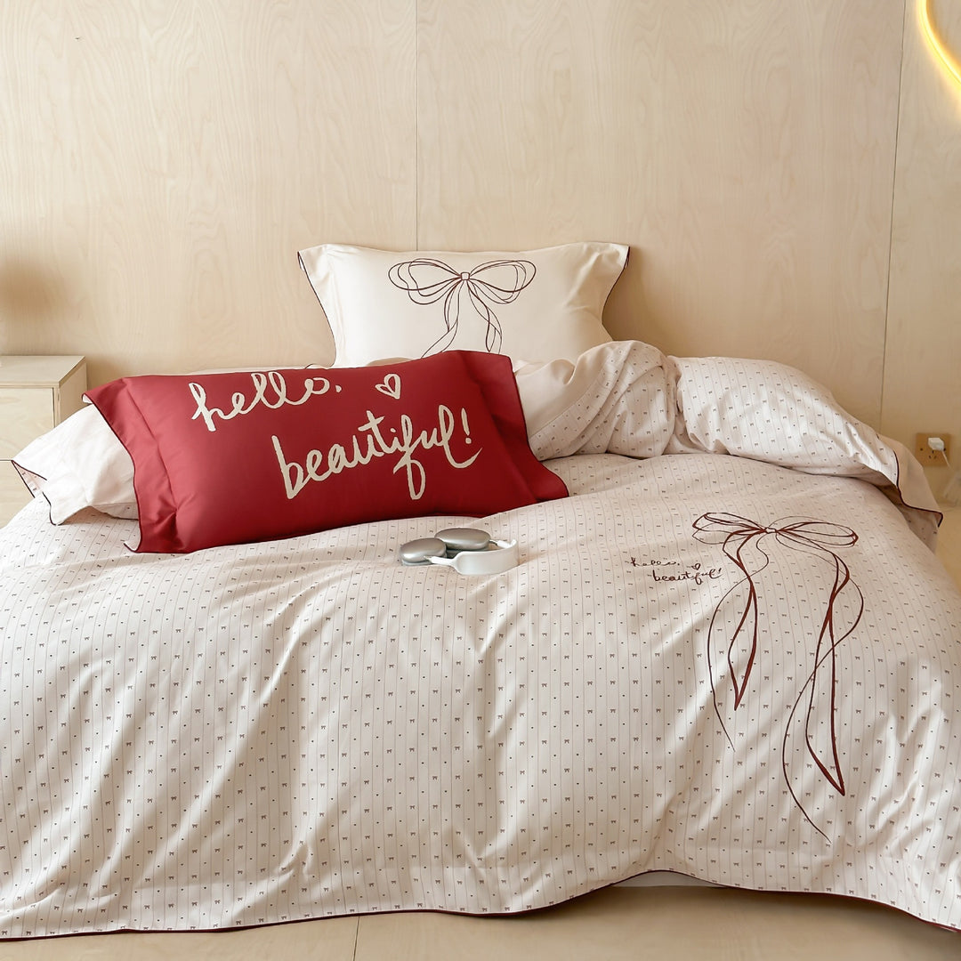 Bedding set made of cotton satin with embroidered bow motif and fine decorative piping
