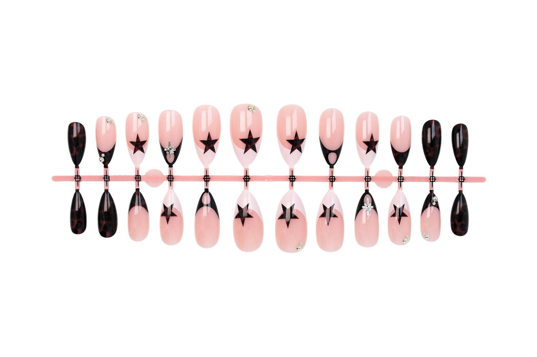 Acrylic nail set with creative star patterns and glitter accents Stornfield