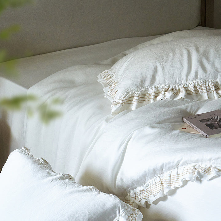 Cotton muslin duvet cover and pillowcase set with ruffle trim and finely striped piping