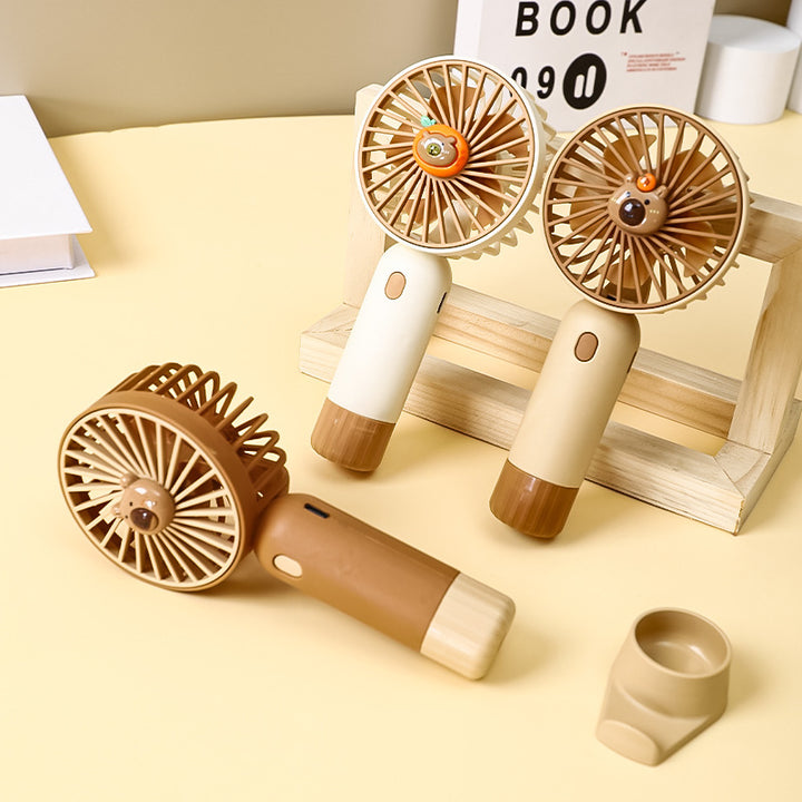 Cooling portable rechargeable handheld mini fan with detachable base stand cute animal-face safety grille USB-C charging Stornfield