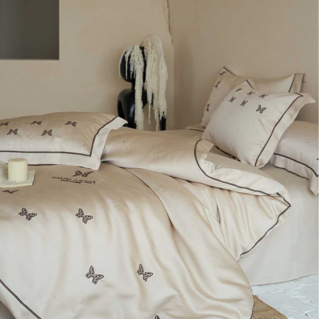Cotton satin bed linen set with fine butterfly embroidery and piping detail