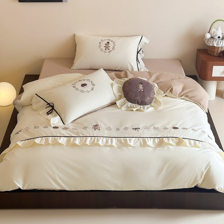 Embroidered bedding set with ruffled trim, teddy design and decorative pillow