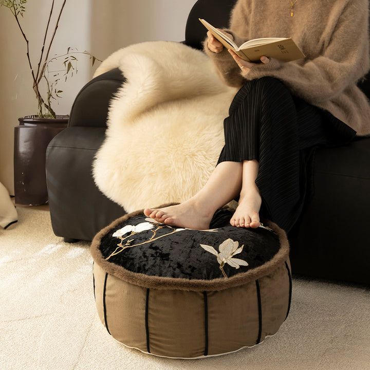 Round upholstered velvet floor cushion pouf with faux fur trim and handle Stornfield