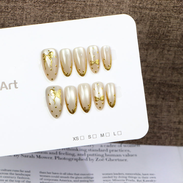 Elegant Press-On Nail Art with Golden Bow Accents Stornfield