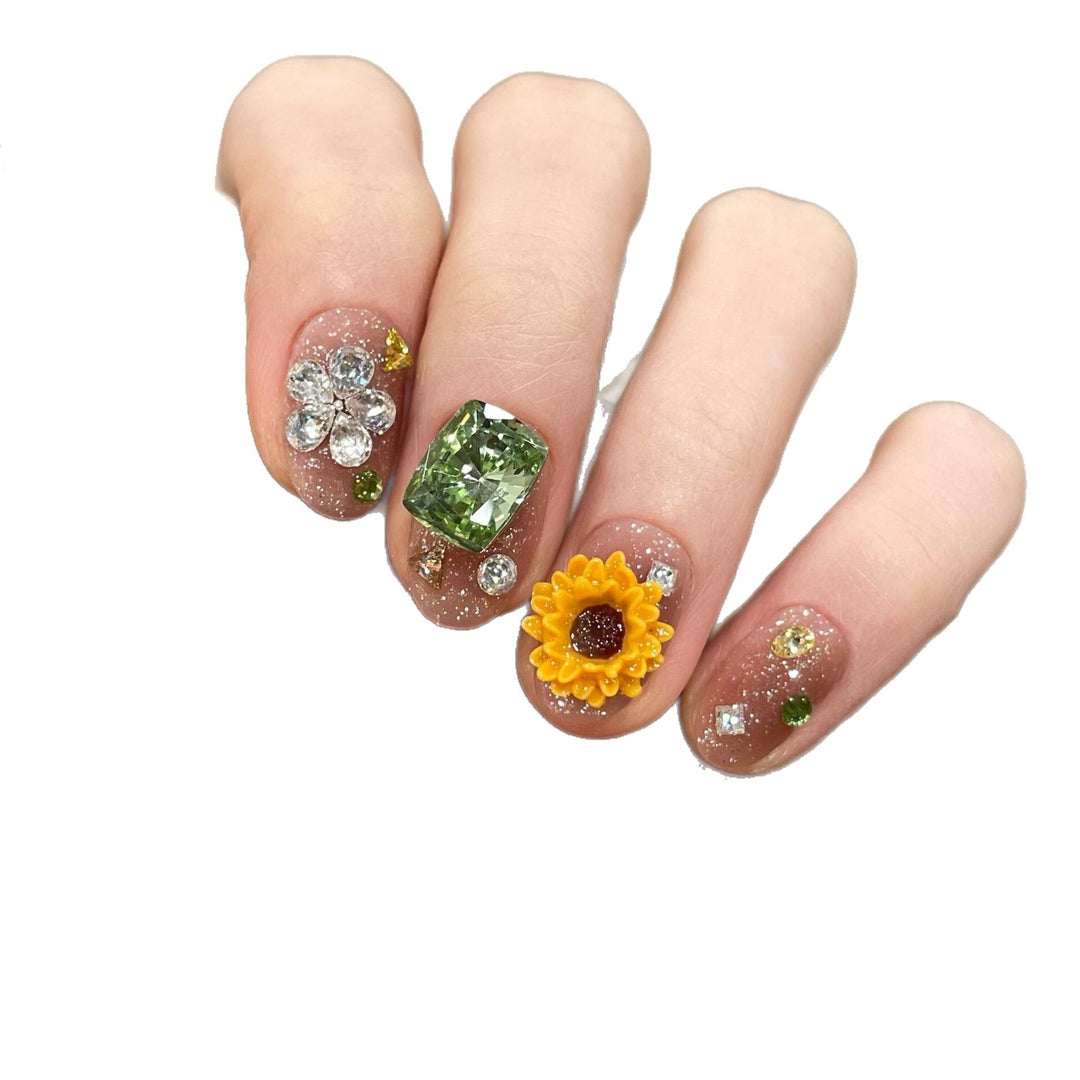 Artificial nails with sparkling appliqués and floral designs Stornfield