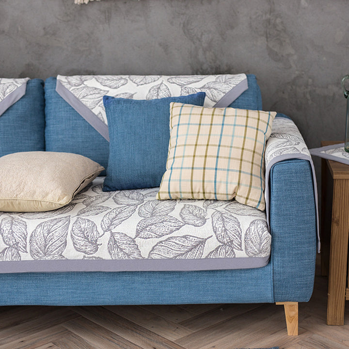 Universal sofa protective cover for three-seater with leaf print, non-slip underside and separate armrest covers Stornfield