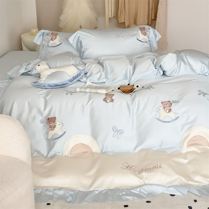 Playful satin bedding set with ruffled border, appliqués and quilted head section