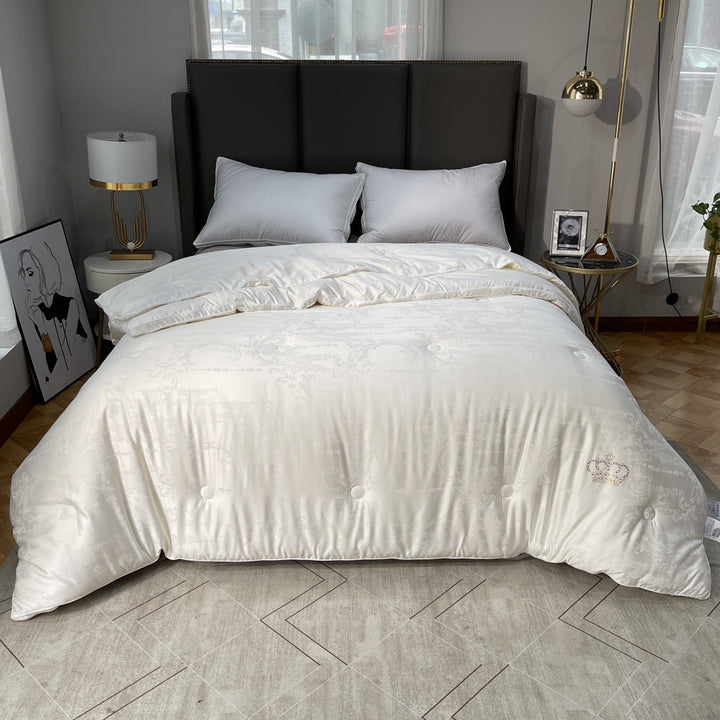 Quilted down look comforter with fine jacquard satin cover and crown embroidery