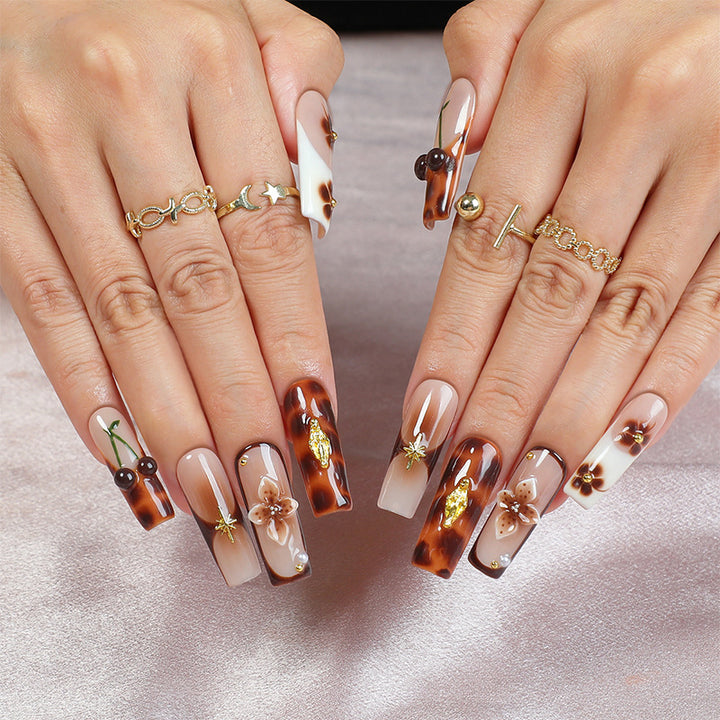 Elegant nail art set with floral and golden accents Stornfield