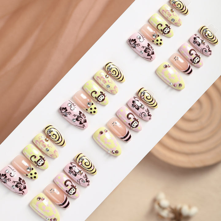 Creative nail art set with playful monkey designs and glitter details Stornfield