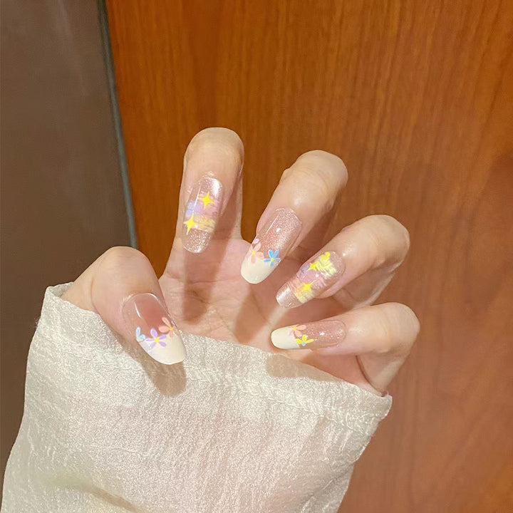 Artificial nails with delicate floral accents and glitter effects Stornfield