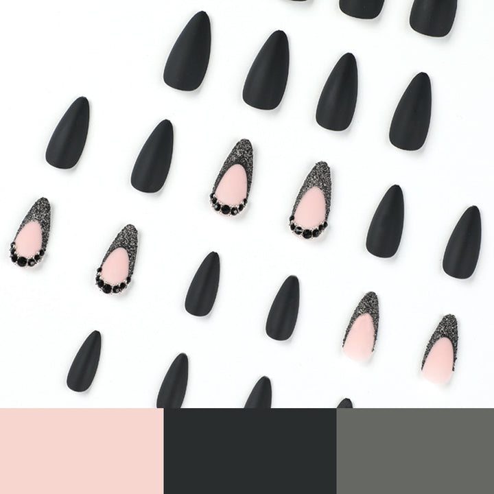 Artful stiletto nails with elegant black design and glitter accents Stornfield