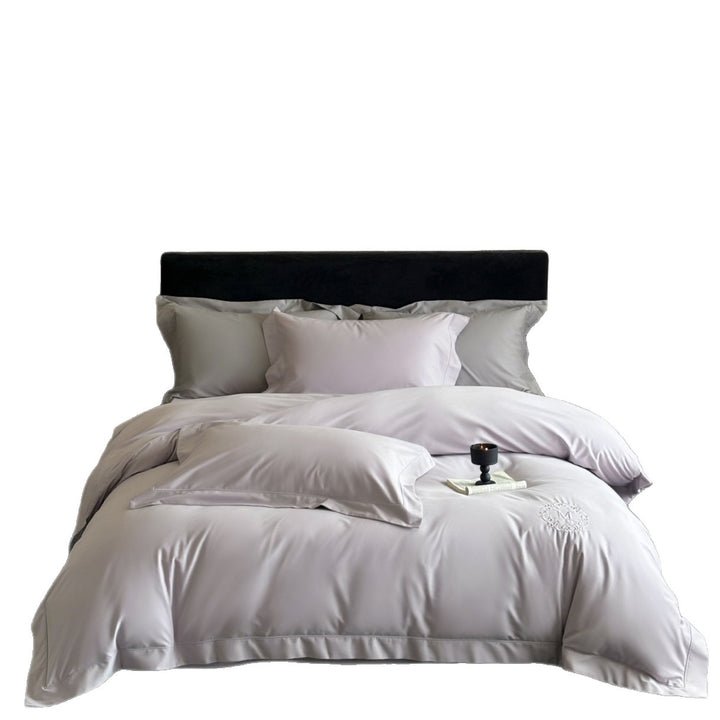 Luxurious cotton satin bedding set with monogram embroidery and fine piping