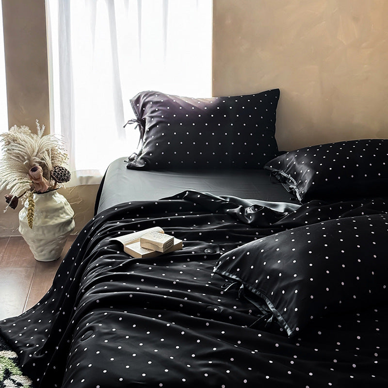 Satin bedding set with delicate polka dot pattern and satin finish