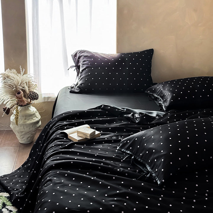 Satin bedding set with delicate polka dot pattern and satin finish