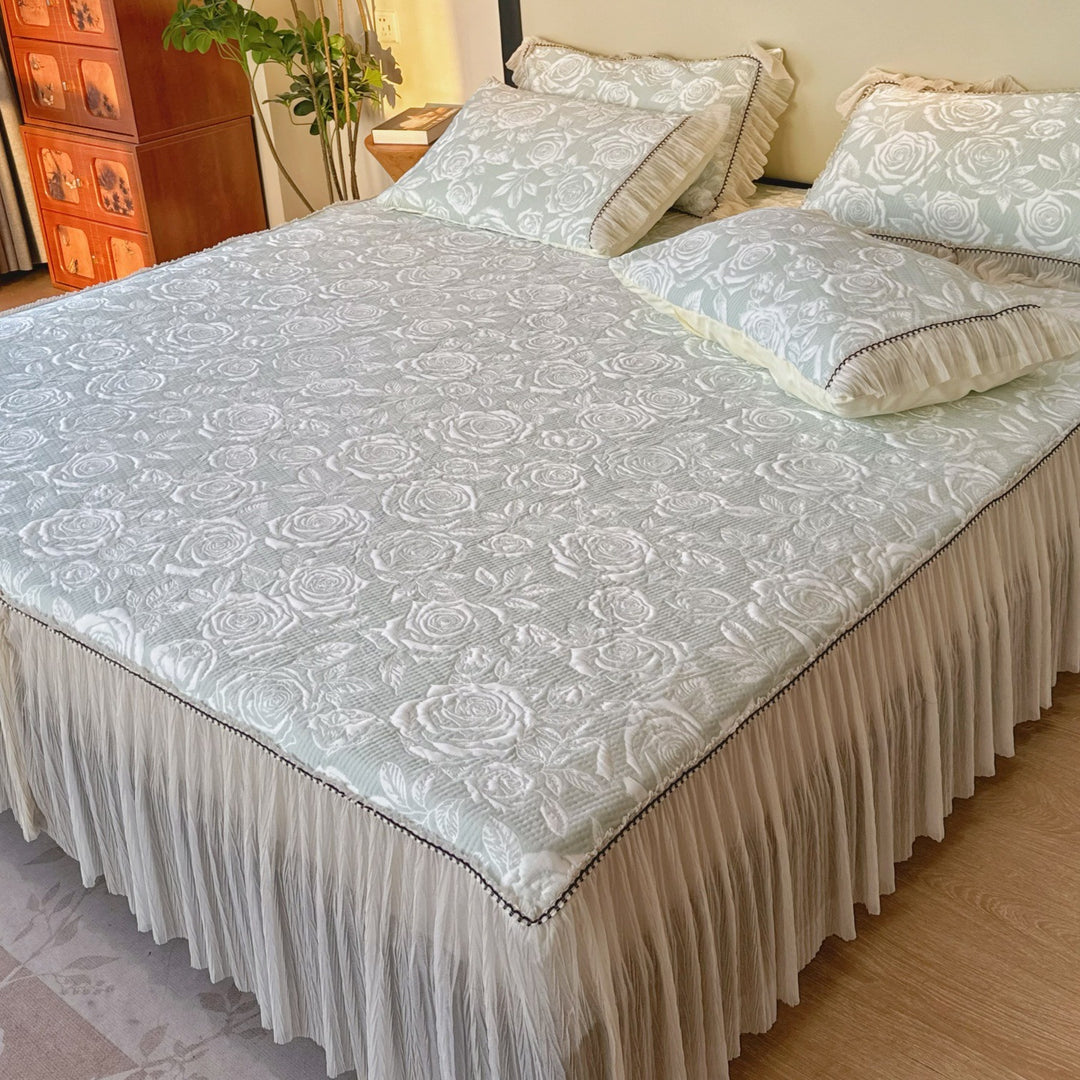 Quilted mattress and pillow set with butterfly motif and pleated bed ruffle