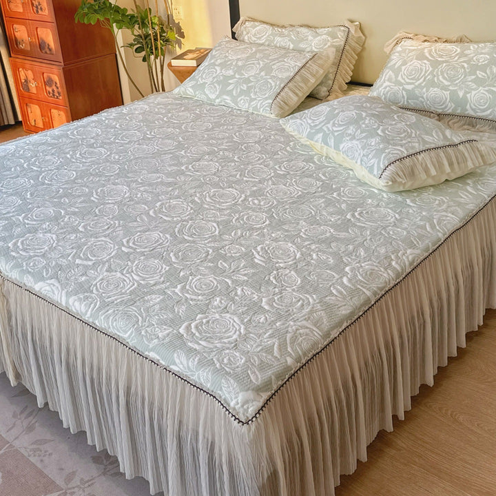 Quilted mattress and pillow set with butterfly motif and pleated bed ruffle