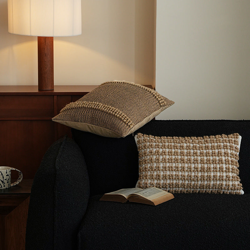 Square Boho decorative cushion made of coarsely woven cotton blend with decorative cord tufts