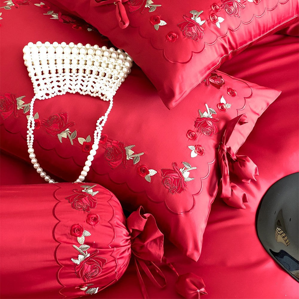 Opulent Satin bedding set with floral embroidery, decorative rolls and ruffled hem
