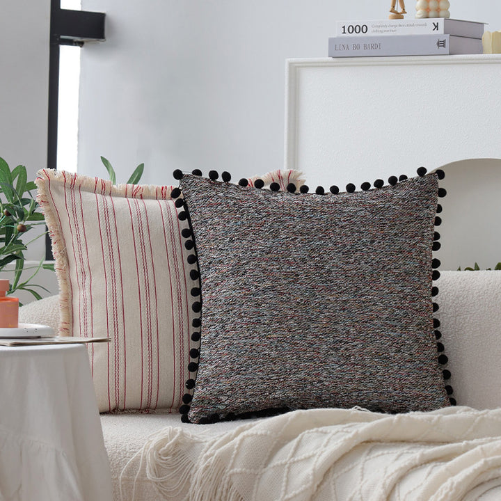 Playful decorative cushion with tassel edge