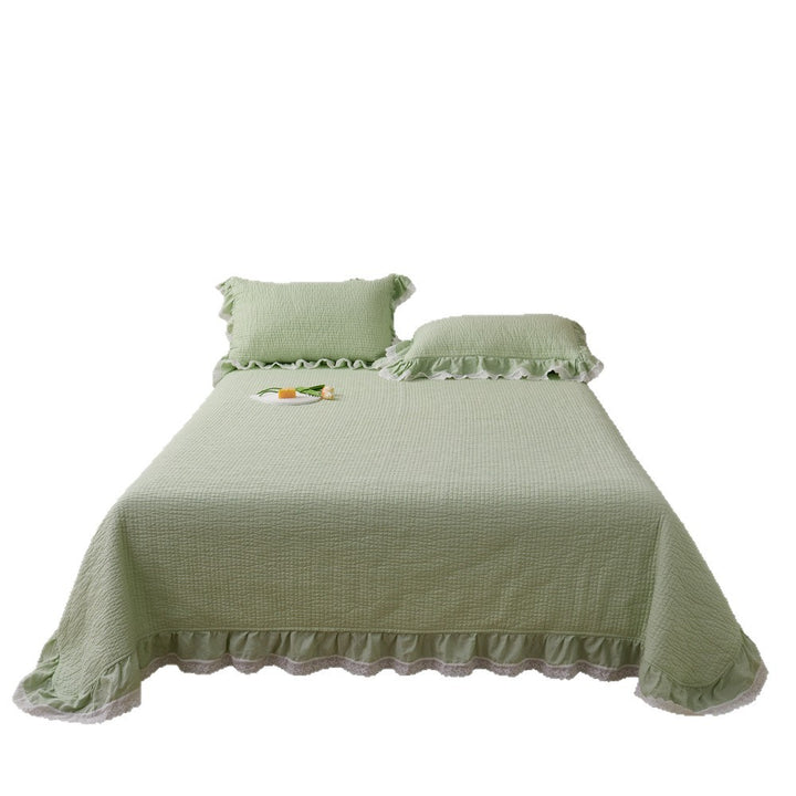 Quilted bed cover set with ruffled hem and lace trim