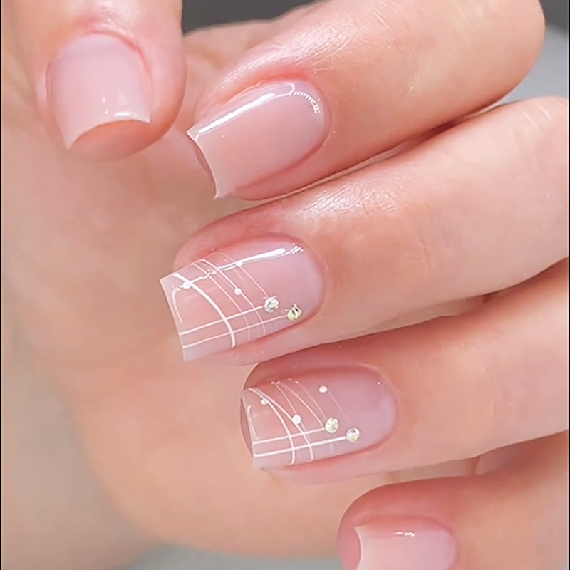 Artful nail extensions with elegant design and rhinestone embellishments Stornfield