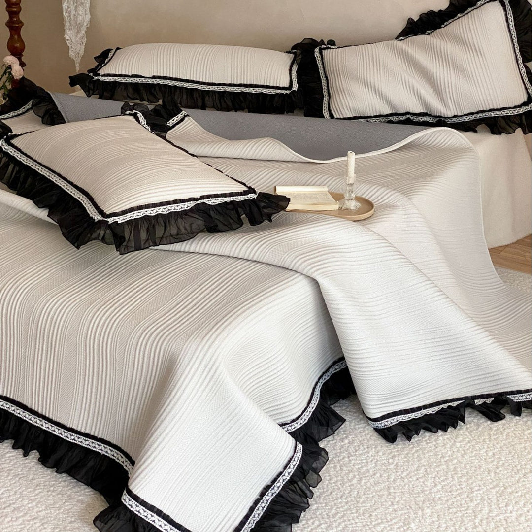 Bedspread with structured wave pattern surface and decorative ruffle trim
