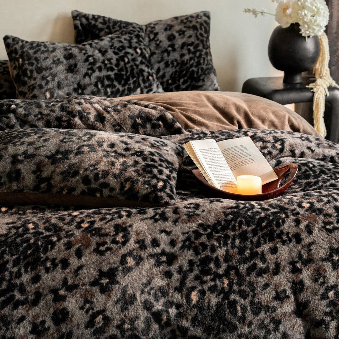 Plush bed cover set with leopard pattern and reversible velvet underside