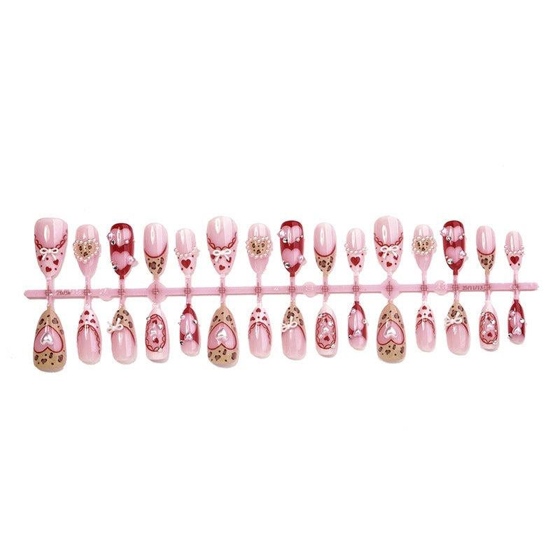 Artificial nail set with romantic heart designs and glamorous 3D details Stornfield