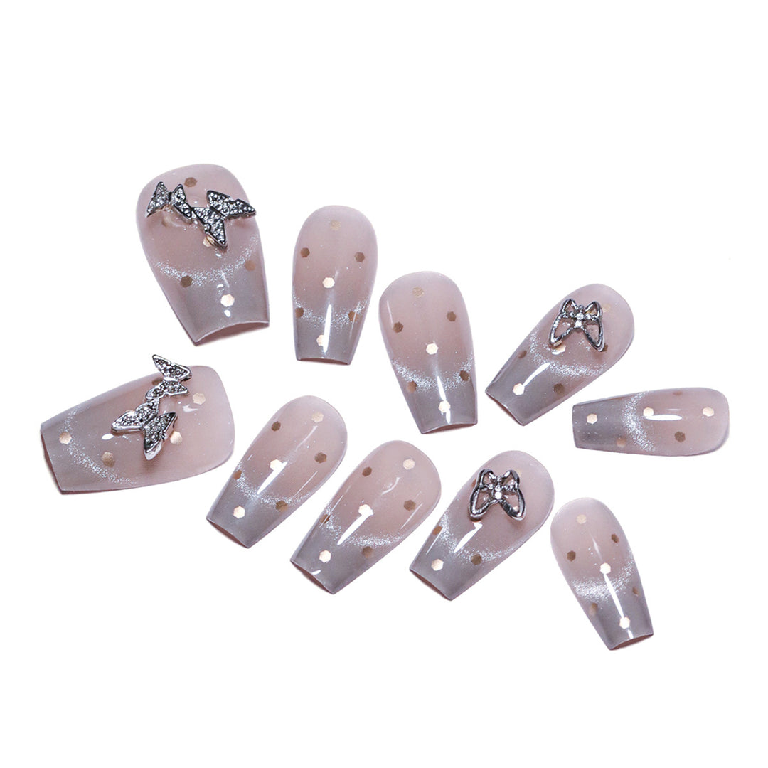 Artificial nail art with glitter details and bow accents Stornfield