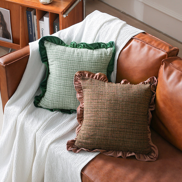 Square decorative pillow with woven linen texture and decorative ruffled edge