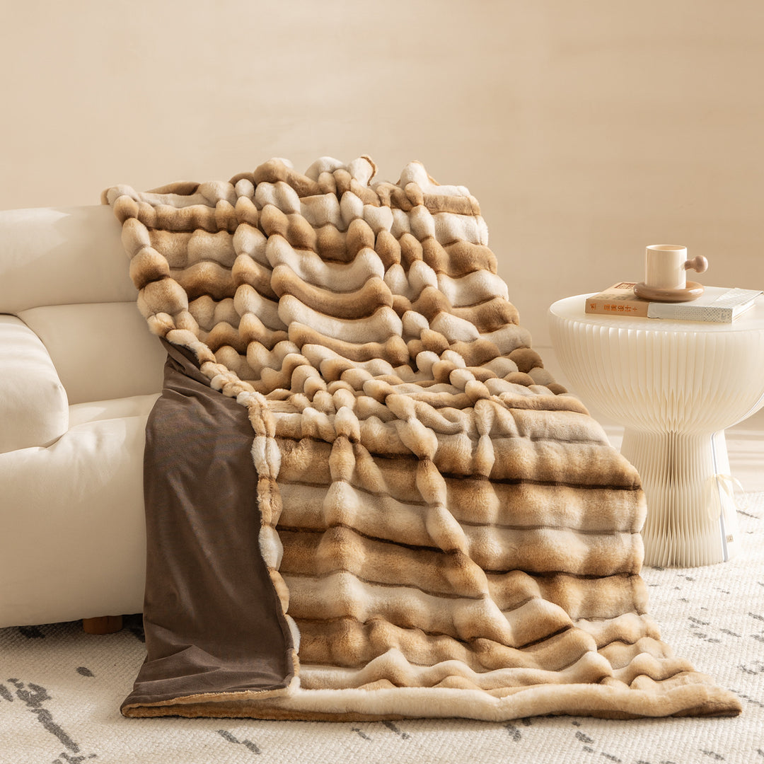 Luxurious faux fur throw blanket with relief-style quilting