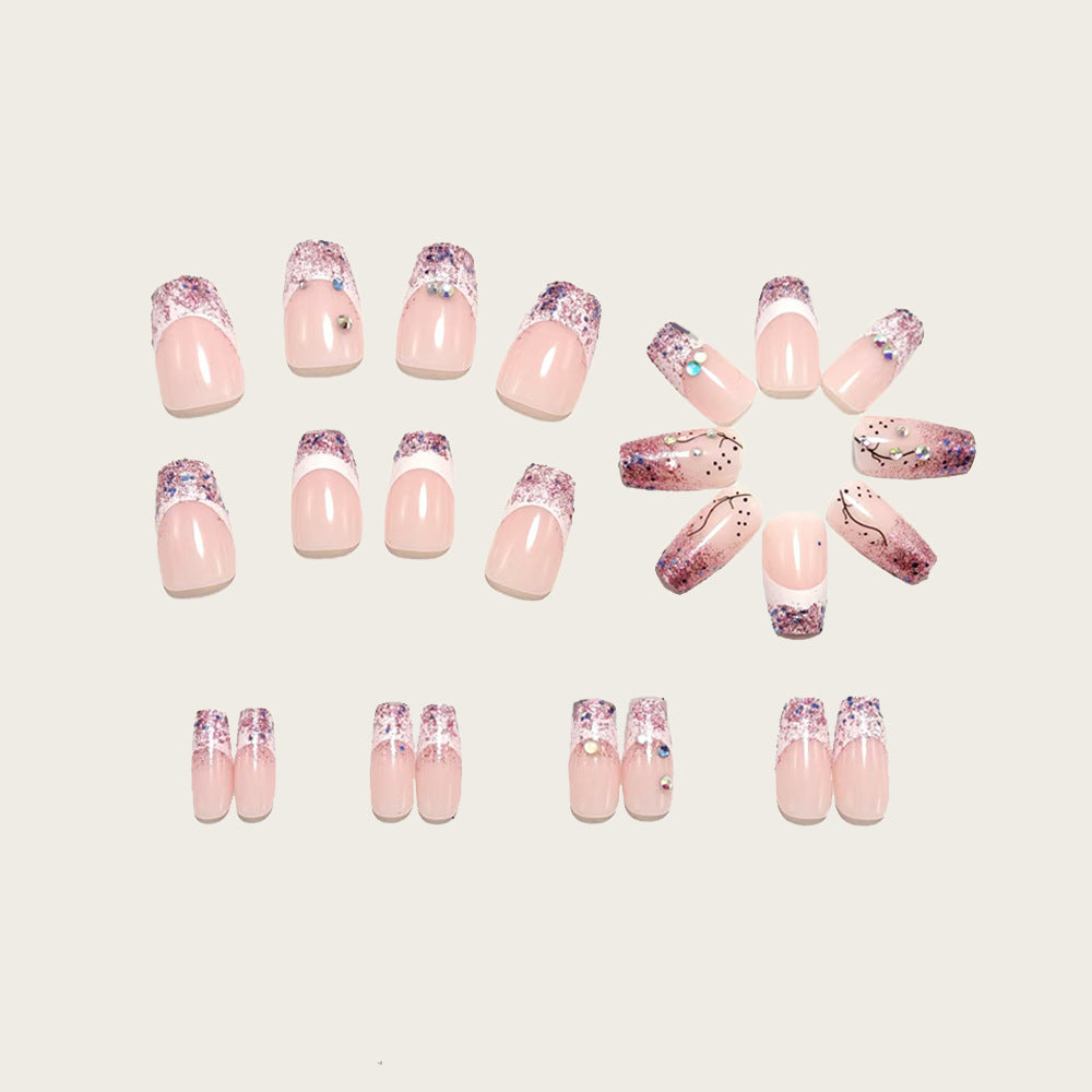 Glamorous artificial nails with glitter and rhinestone embellishments Stornfield