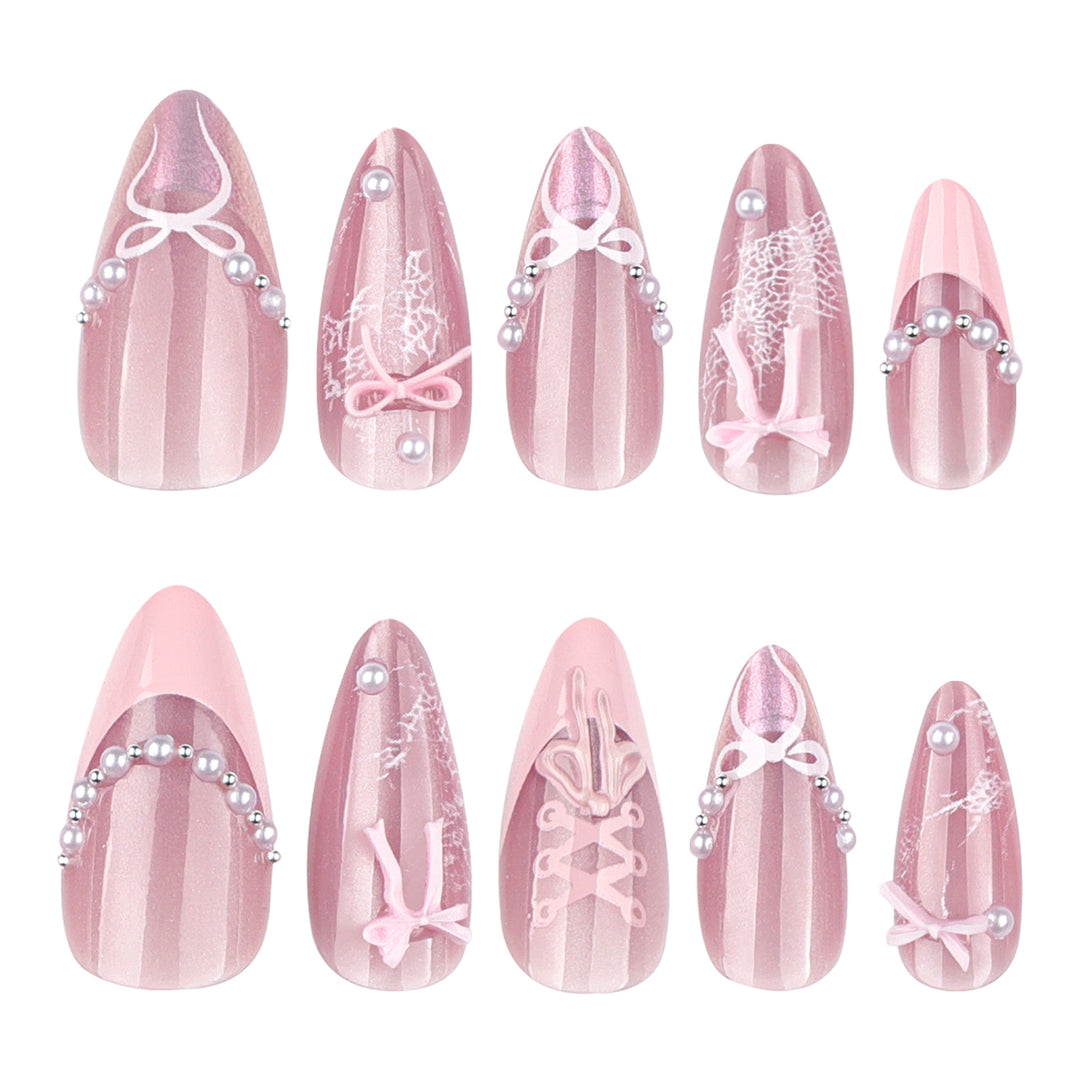 Artful nail extensions with delicate bow motifs Stornfield