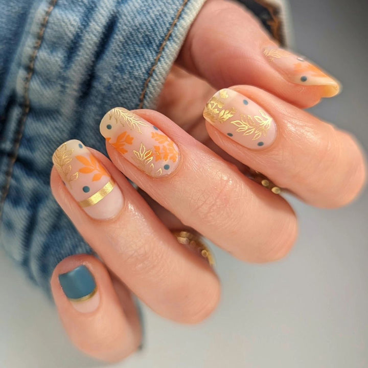 Artistic nail design with floral and golden accent Stornfield