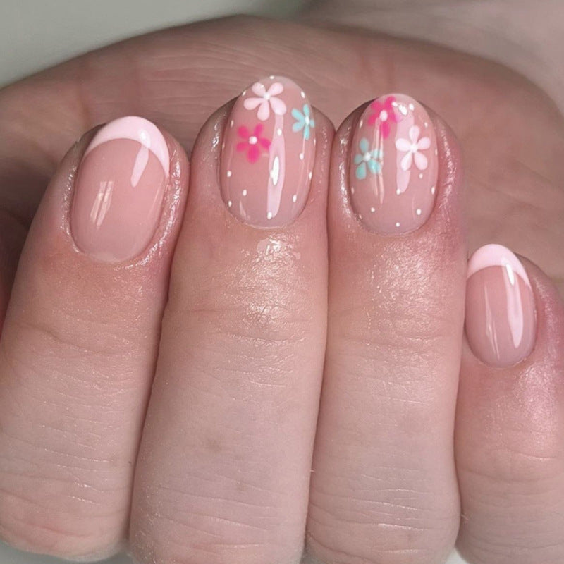 Artful nail extensions with colorful floral designs and glitter Stornfield