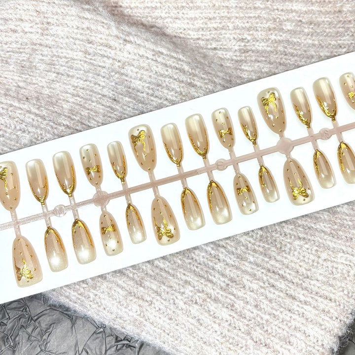 Elegant Press-On Nail Set with Gold Bow Accents