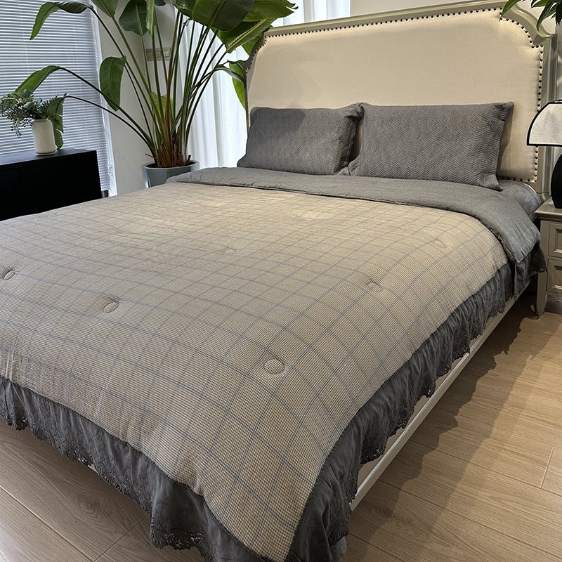 Quilted bedspread with lace trim and vintage stripe pattern