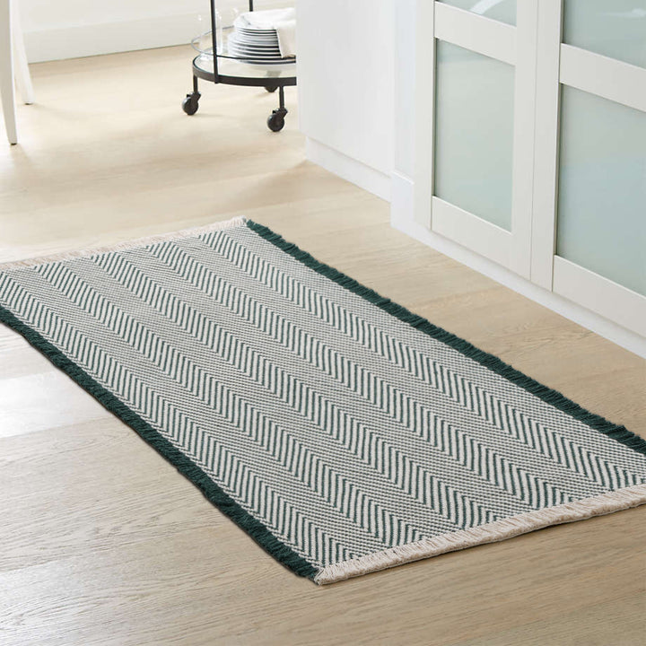 Handwoven cotton bath mat with herringbone pattern and fringes Stornfield