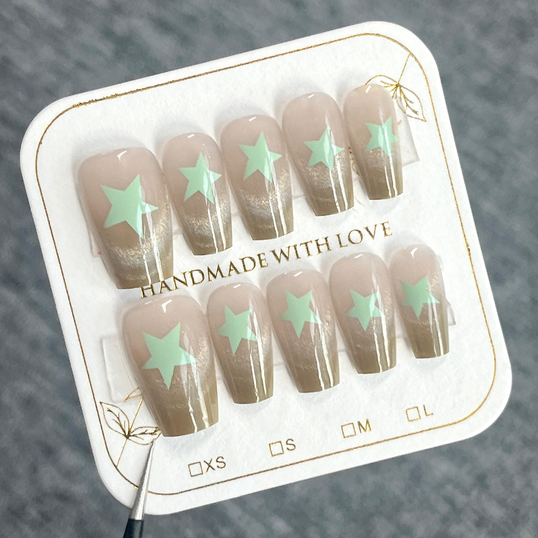 Artificial nail extensions with shimmer effect and star motifs Stornfield