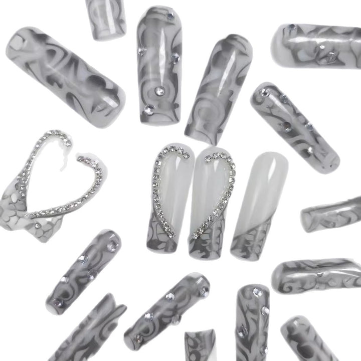 Artificial nails with elegant 3D pattern and radiant rhinestone decorations Stornfield