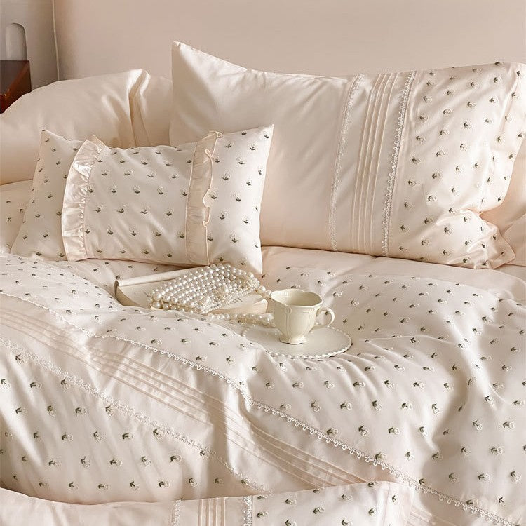 Exclusive satin bedding set with all-over rosebud embroidery and pleating details
