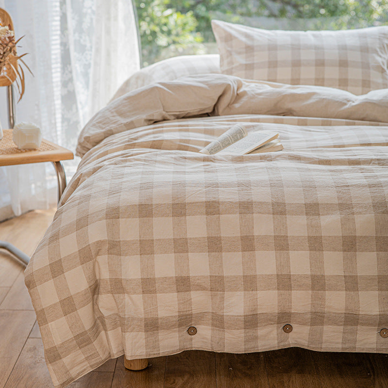 Reversible linen look duvet cover with large check pattern and wooden button closure