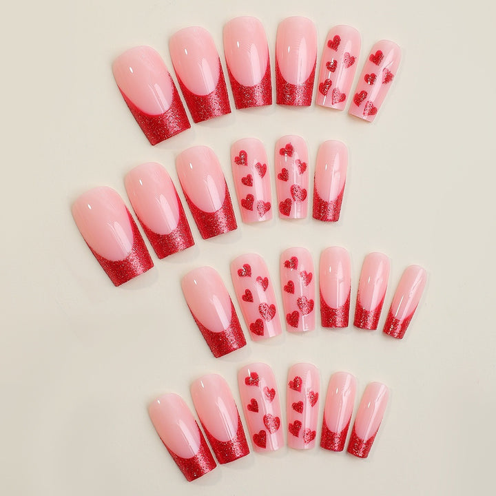 Artificial nail set with romantic heart designs and glitter accents Stornfield