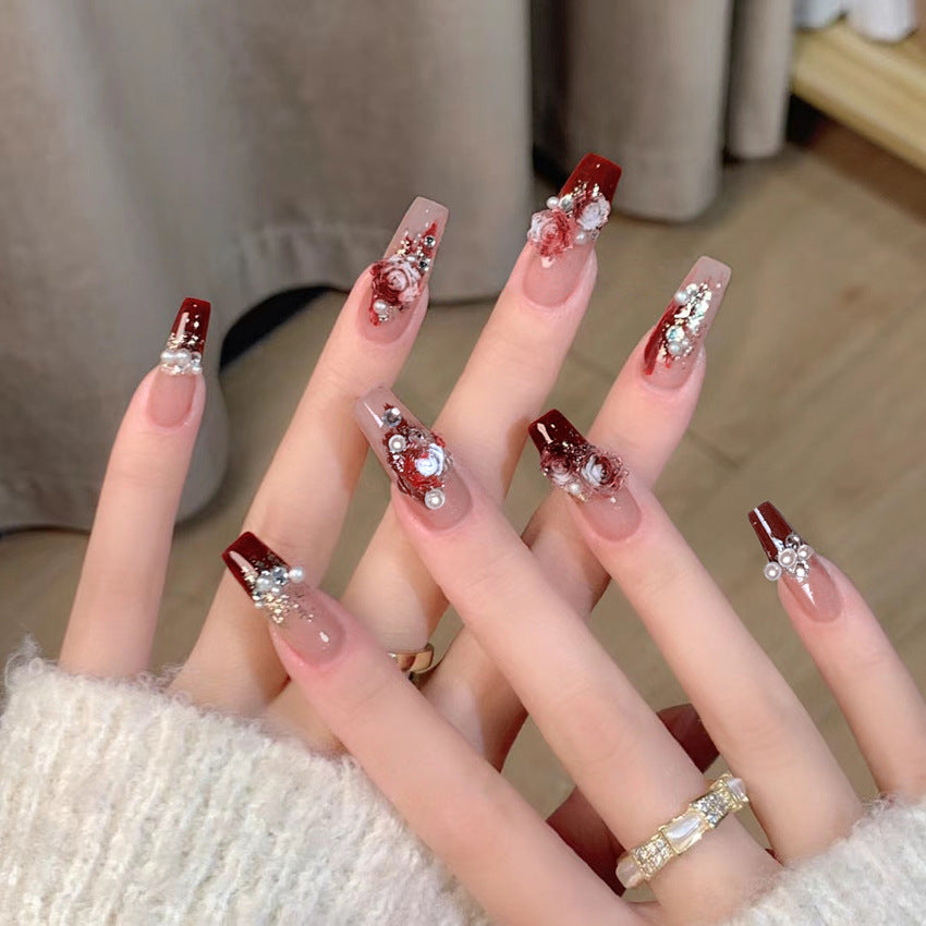 Glamorous artificial nails with delicate flower and glitter effects Stornfield